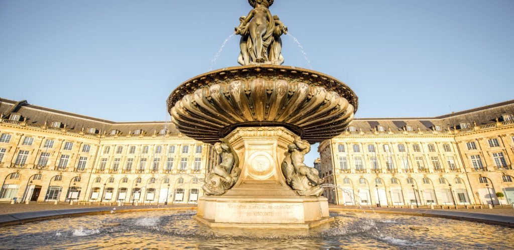 Bordeaux city in France View on the famous Three Graces fountain on La Bourse square during the morning in Bordeaux city, France
